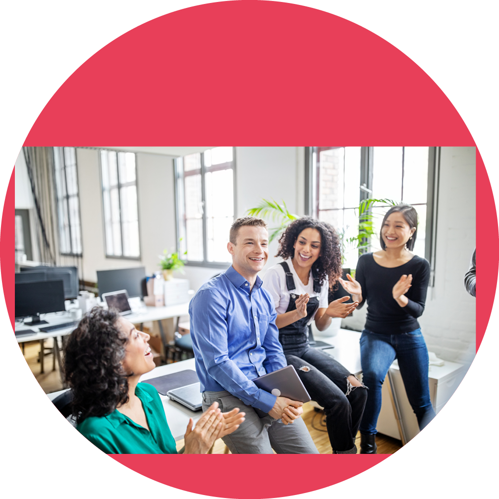 Smiling mature businessman with colleagues clapping hands in office  Business people clapping for male colleague in office 