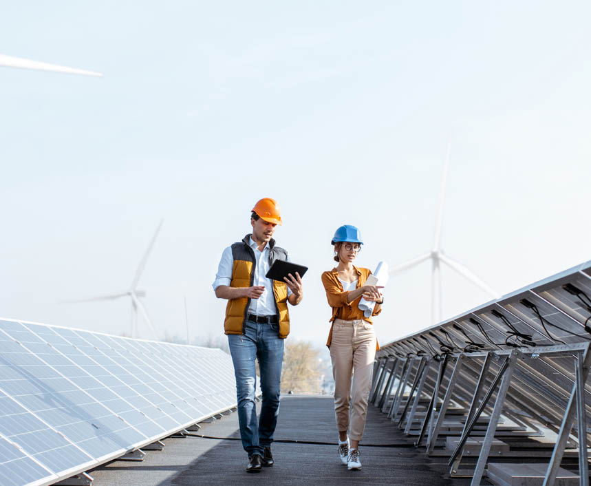 View on the rooftop solar power plant with two engineers walking and examining photovoltaic panels  Concept of alternative energy and its service